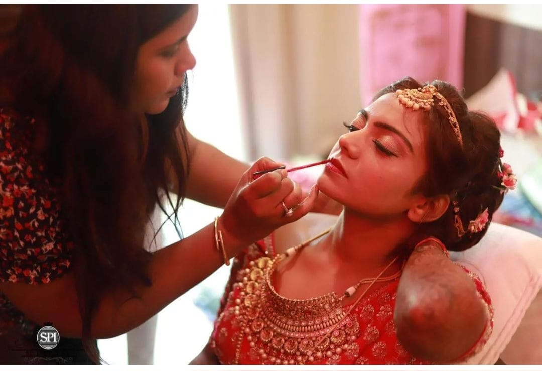 Rajni Mitra applying bridal makeup